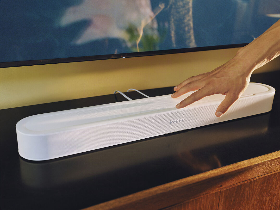 Sonos Beam Ultra with hand touching it